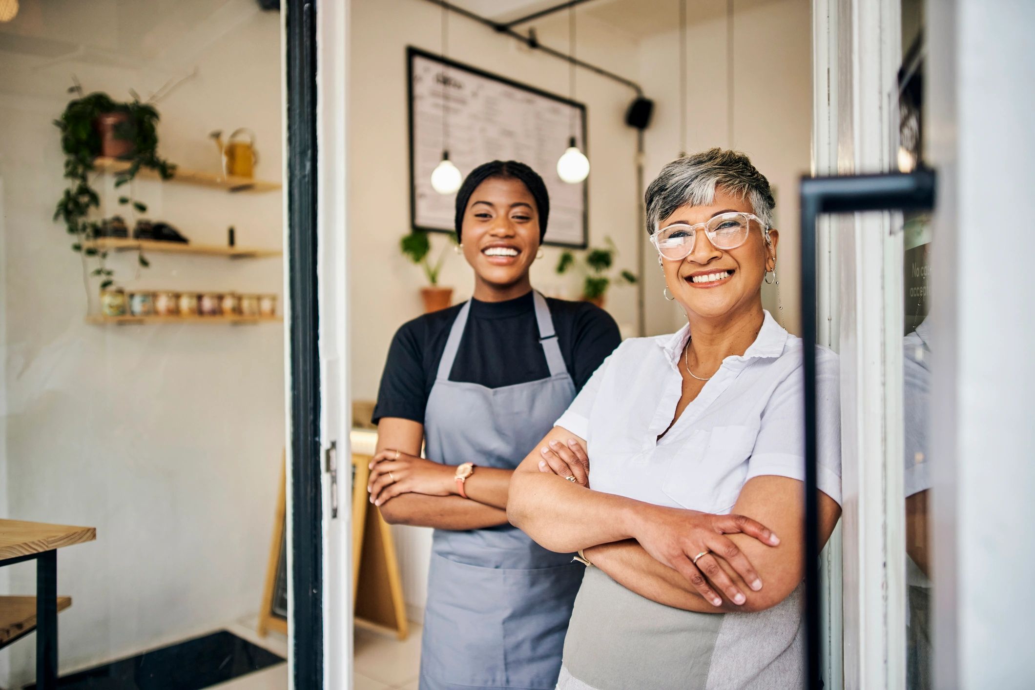 two women small business owners, upscale, elegant, smiling, modern background